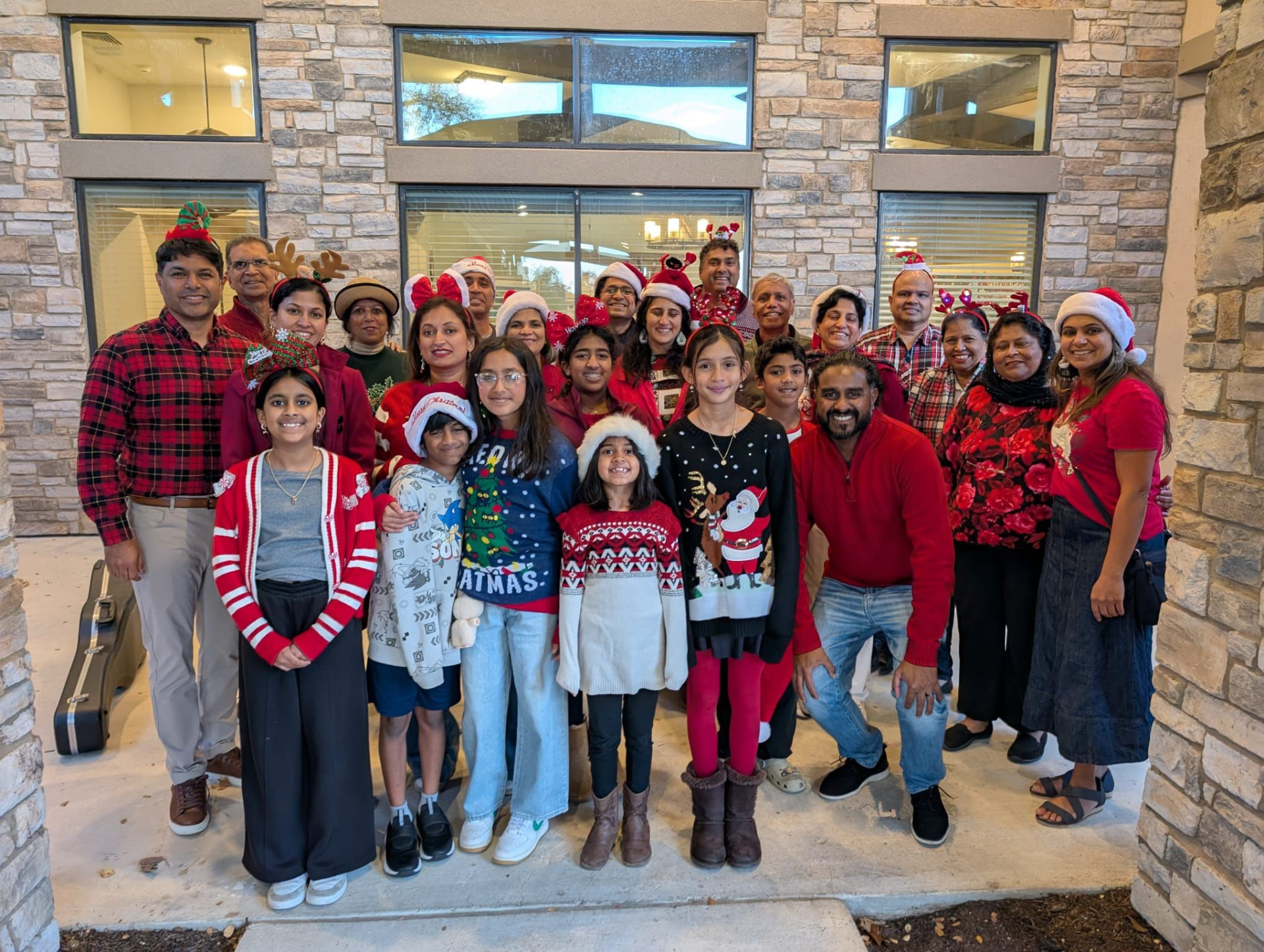 ICA community members gathered in festive clothing for Christmas 2025