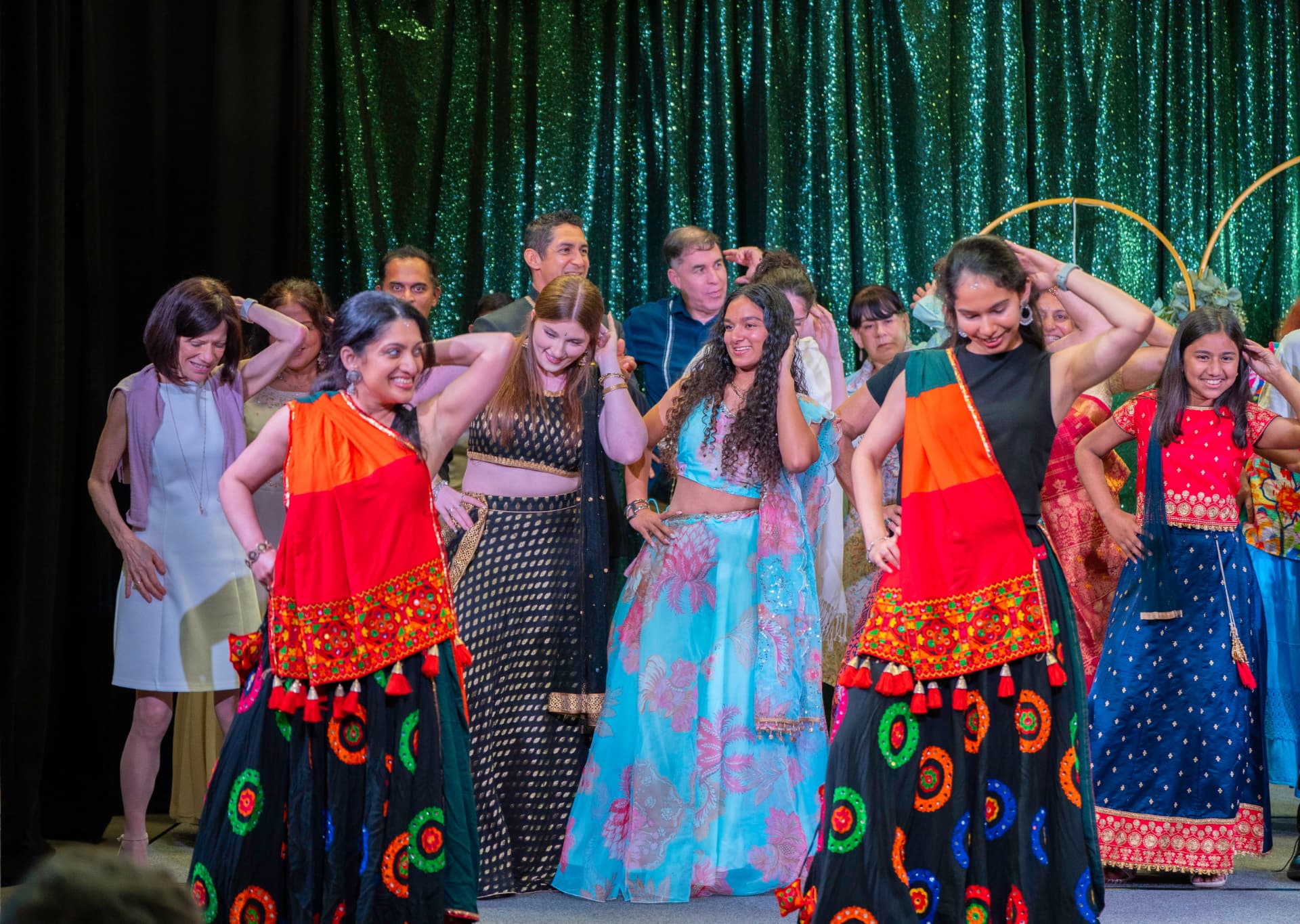 Guests and performers dance together on stage at Taste of India 2026