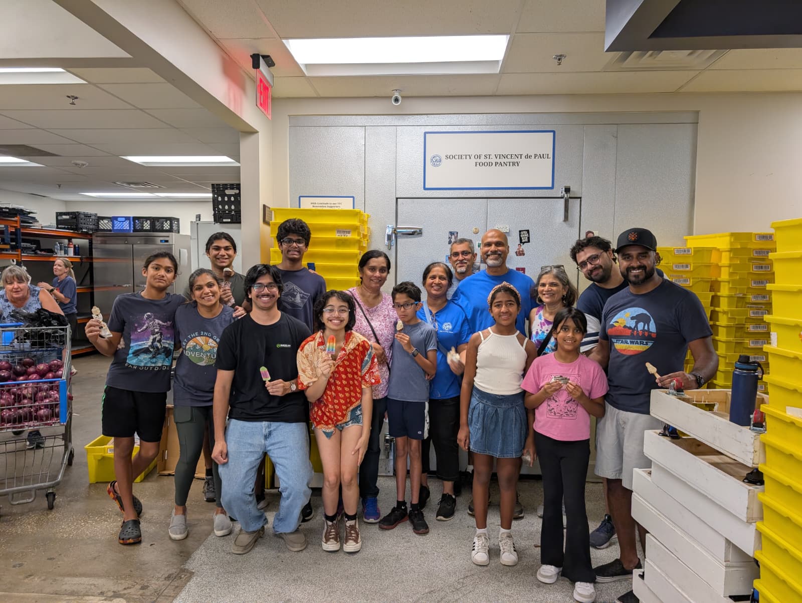 ICA adults and youth volunteering at the St. Vincent de Paul food pantry in 2025