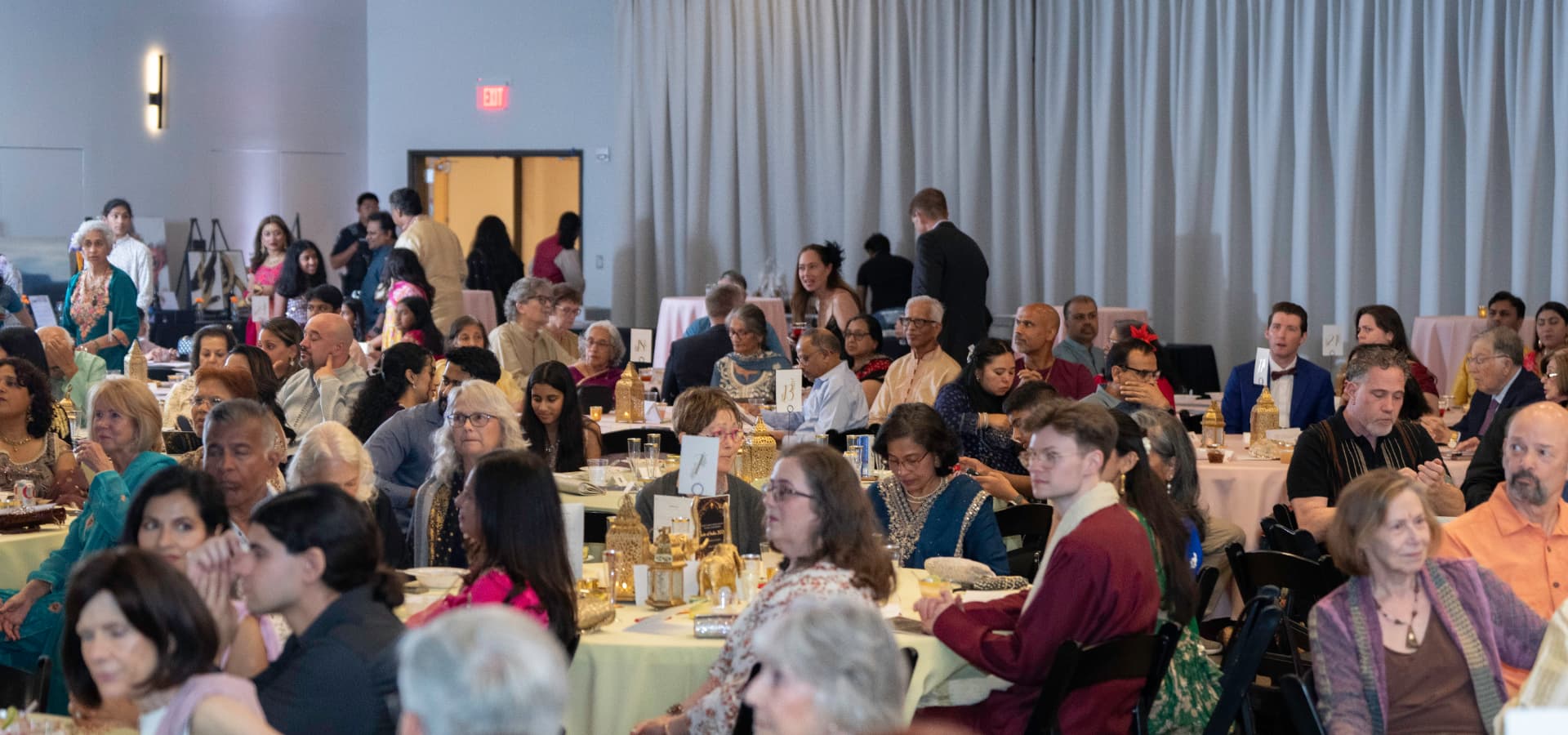 Guests seated at decorated round tables during the Taste of India 2026 fundraiser